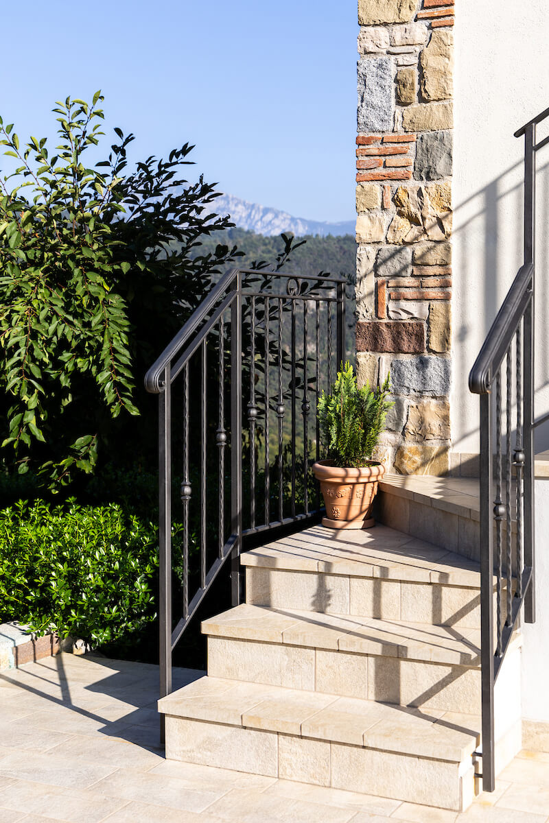 External details of the house with stone walls and traditional iron railings